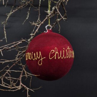 Christbaumkugel aus Glas mit Samtflockung und „Merry Christmas“.